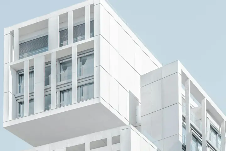 White commercial building facade against a clear sky