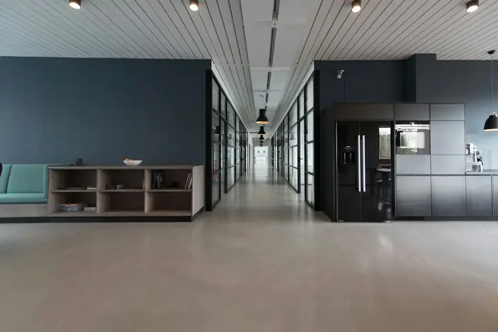 Open-plan office with glass partitions and polished floor